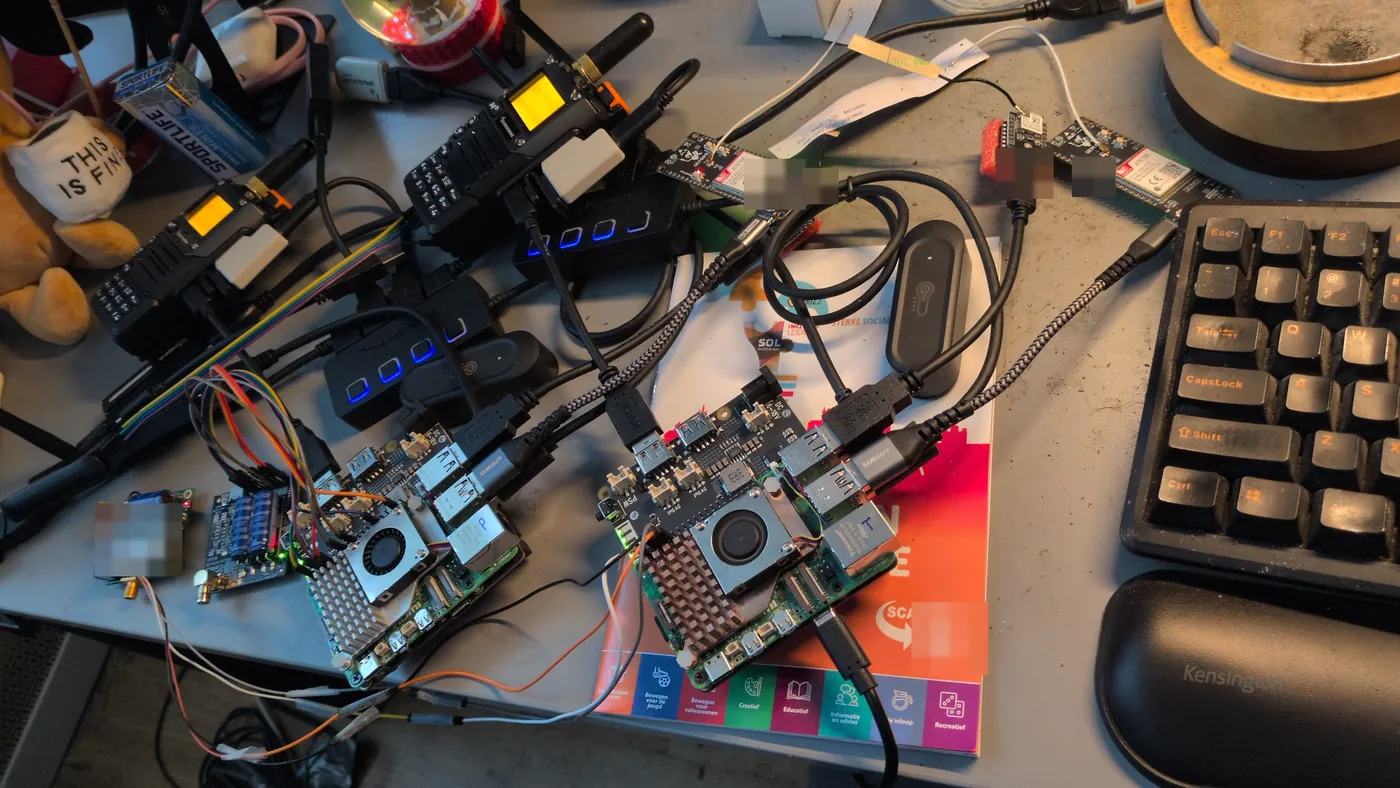 Two Raspberry Pi field kits half assembled side by side on a desk, radios and cables around them.