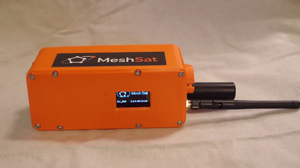 MeshSat Compact v2, the first prototype: mesh radio, satellite modem and battery in one hand-sized case. It has sent and received satellite messages.